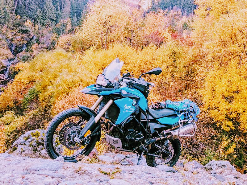 F800GS parked on a rocky overlook with autumn foliage