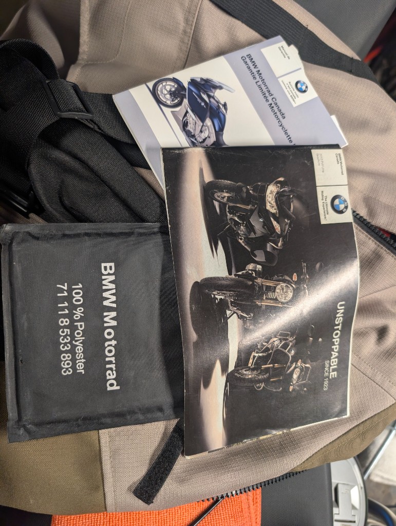 2013 BMW brochure, warranty card, and document pouch